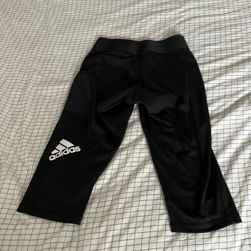 Black knee length Adidas leggings. With packet dry fit material.